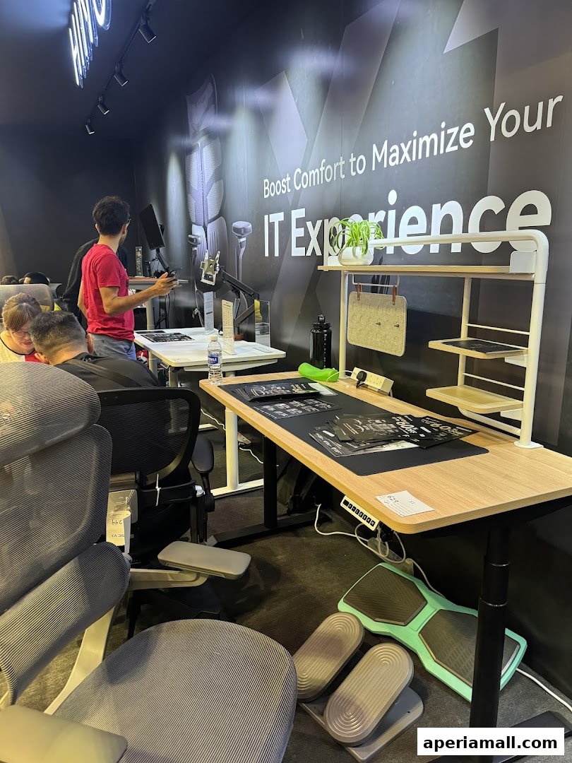 Showroom interior with ergonomic chairs, adjustable desks, and people browsing.