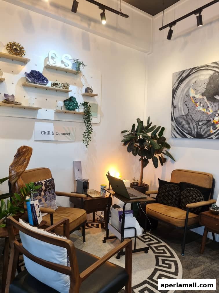 Interior shot of a cozy wellness space with chairs, plants, and decorative shelves.