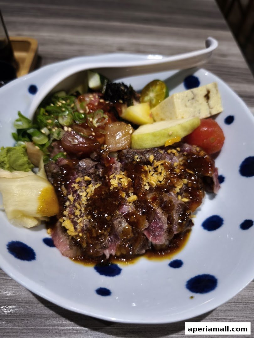 A delicious bowl of donburi with thinly sliced beef, fresh vegetables, and a savory sauce.