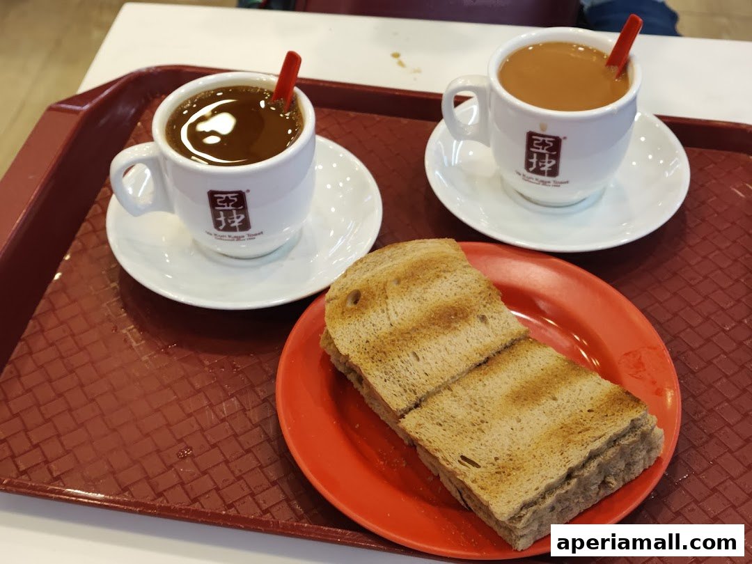 Two cups of coffee and toast served on a tray at Ya Kun Kaya Toast.