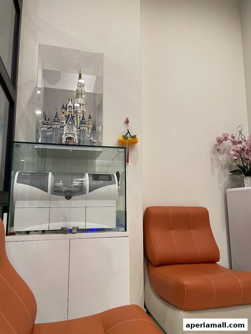 Interior shot of a dental clinic waiting area with chairs, a display of a castle, and dental equipment.