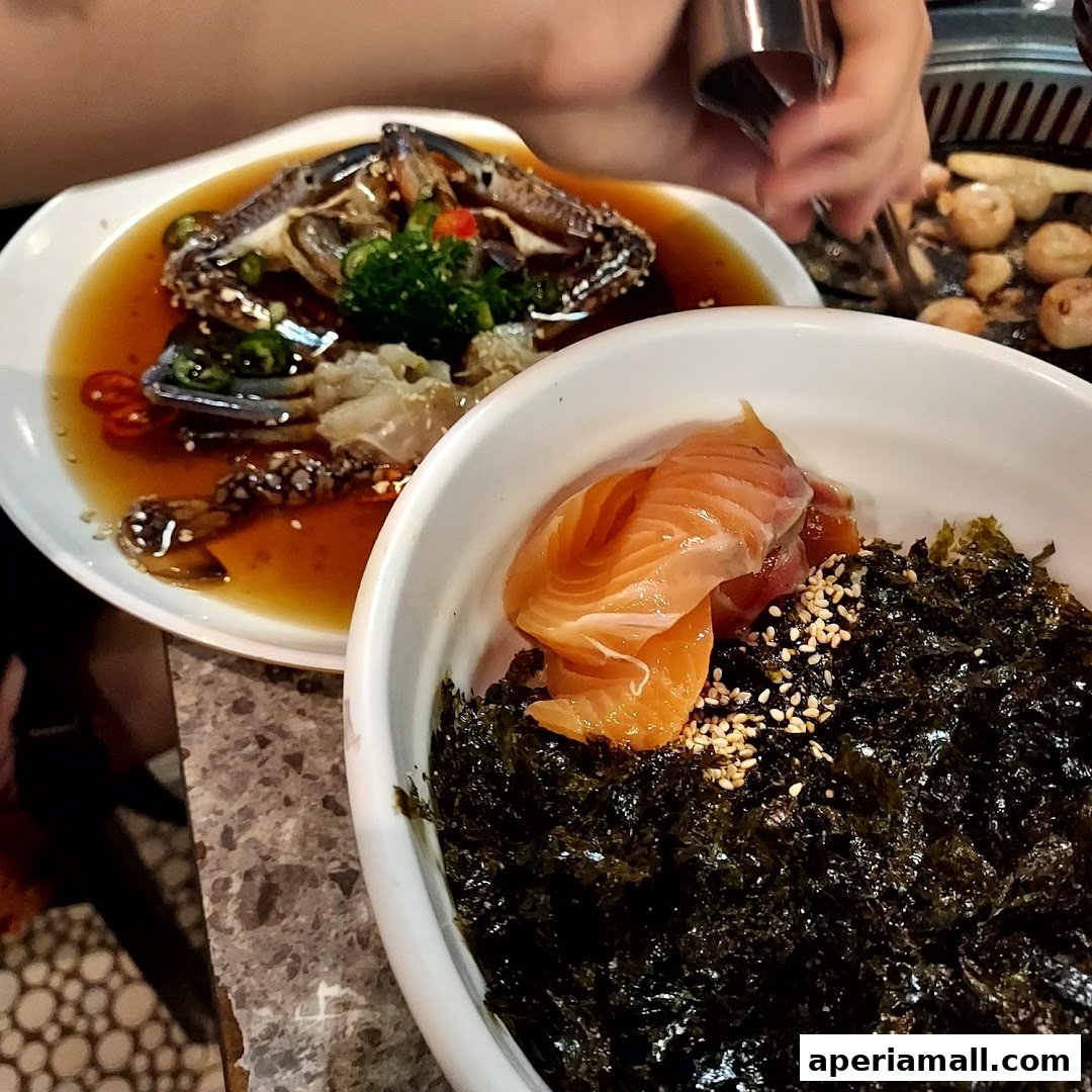 A close-up of two delicious seafood dishes, one with marinated crab and the other with salmon and seaweed.