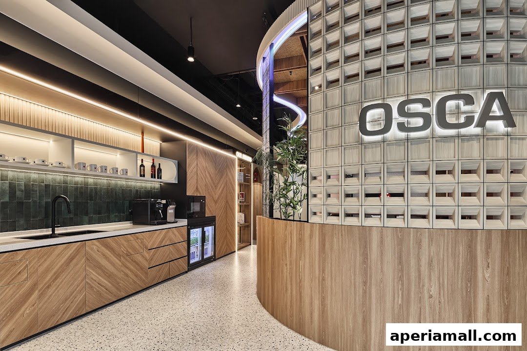 Modern interior with a reception desk, coffee station, and decorative wall.
