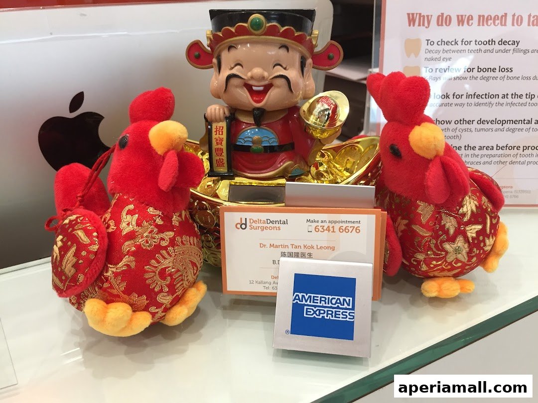 Delta Dental Surgeons display with Chinese New Year decorations and an American Express card.