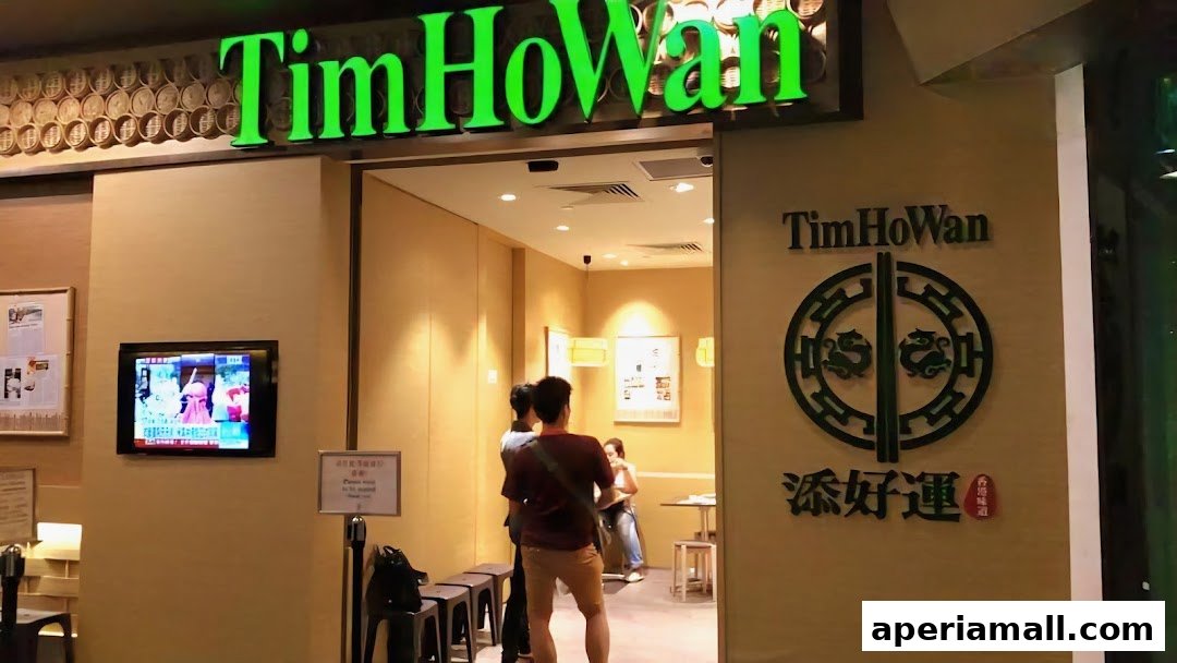 The entrance to Tim Ho Wan restaurant, featuring its prominent green signage and logo.