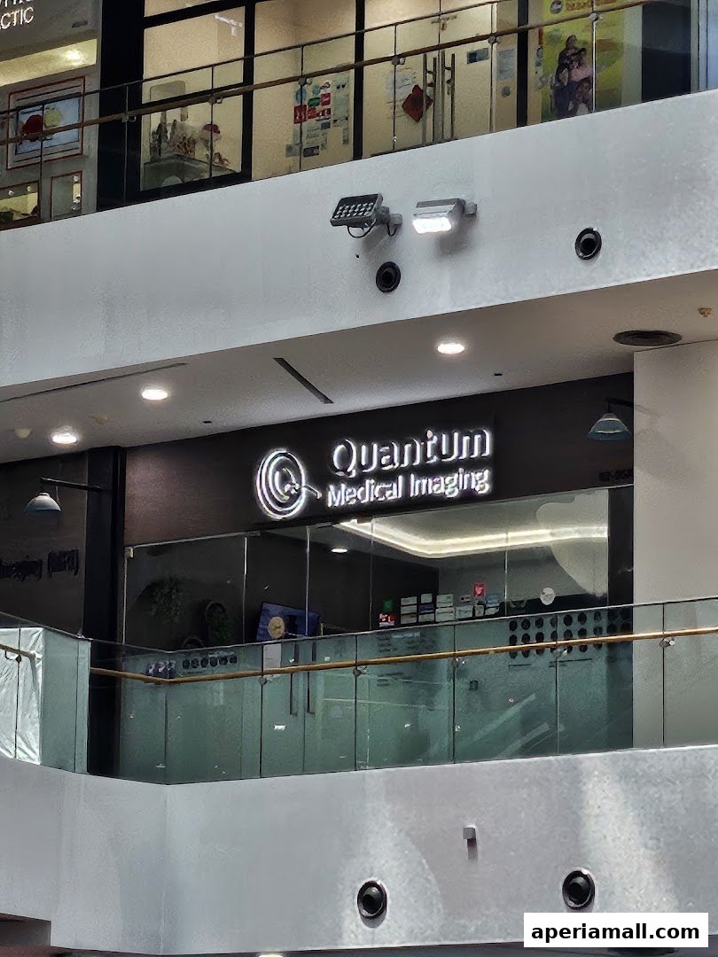 The storefront of Quantum Medical Imaging, a modern clinic with a prominent illuminated sign.