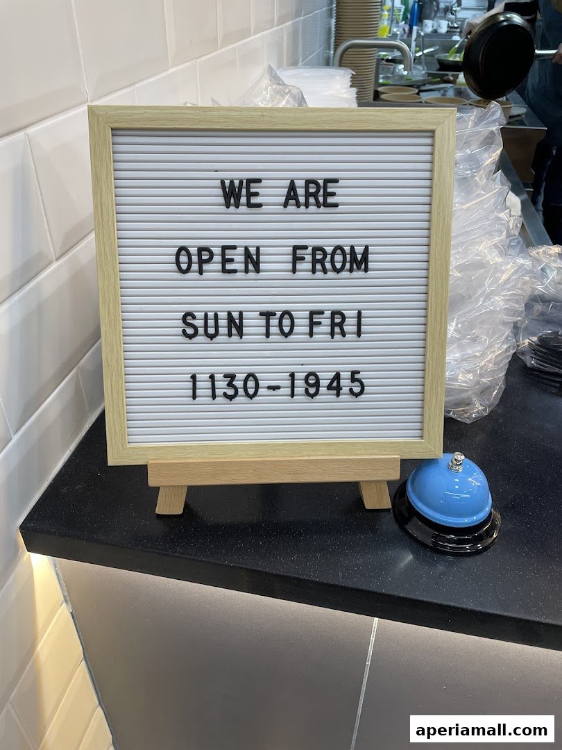 A sign announcing operating hours for Little Ribbons Pasta Co. with a service bell.