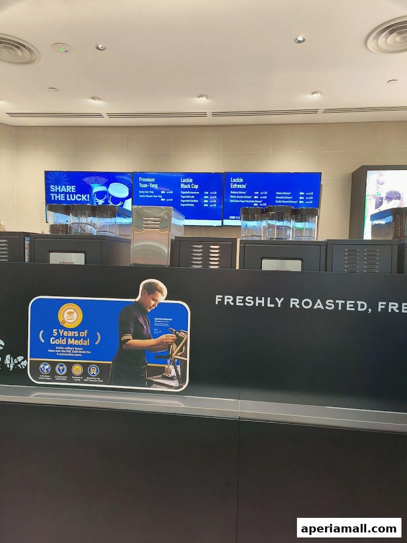 Luckin Coffee shop interior with digital menus displaying drinks and a promotional poster.