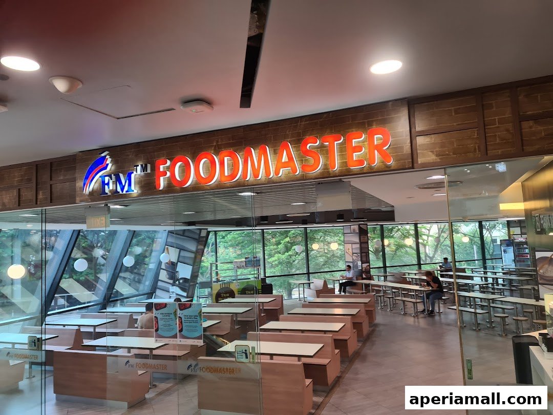 The entrance of FM FoodMaster, a restaurant with seating and a prominent sign.