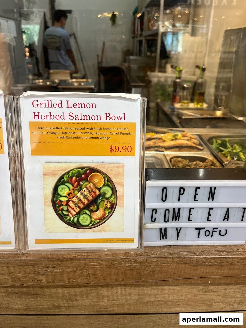 A menu display for a Grilled Lemon Herbed Salmon Bowl at a salad bar.
