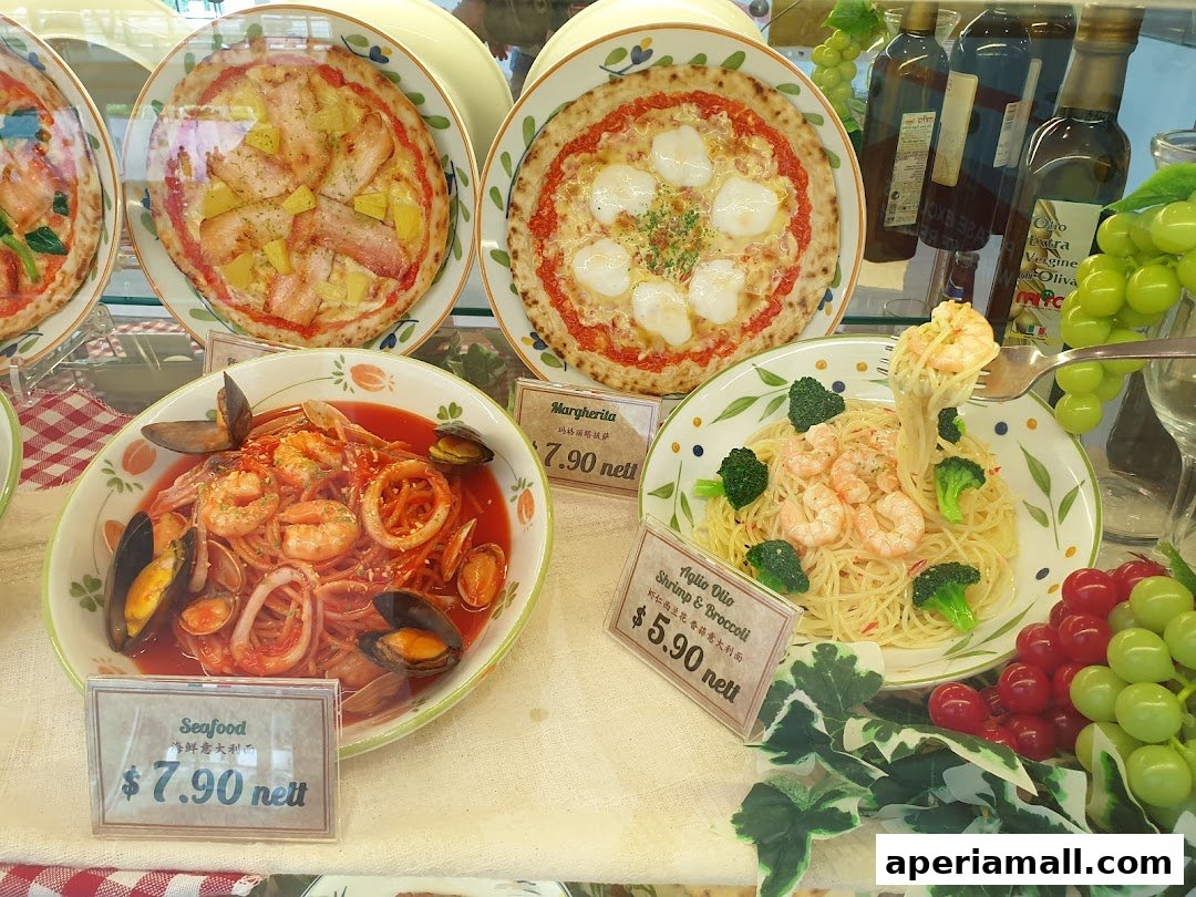 A display of realistic food models including pizzas, seafood pasta, and shrimp pasta.