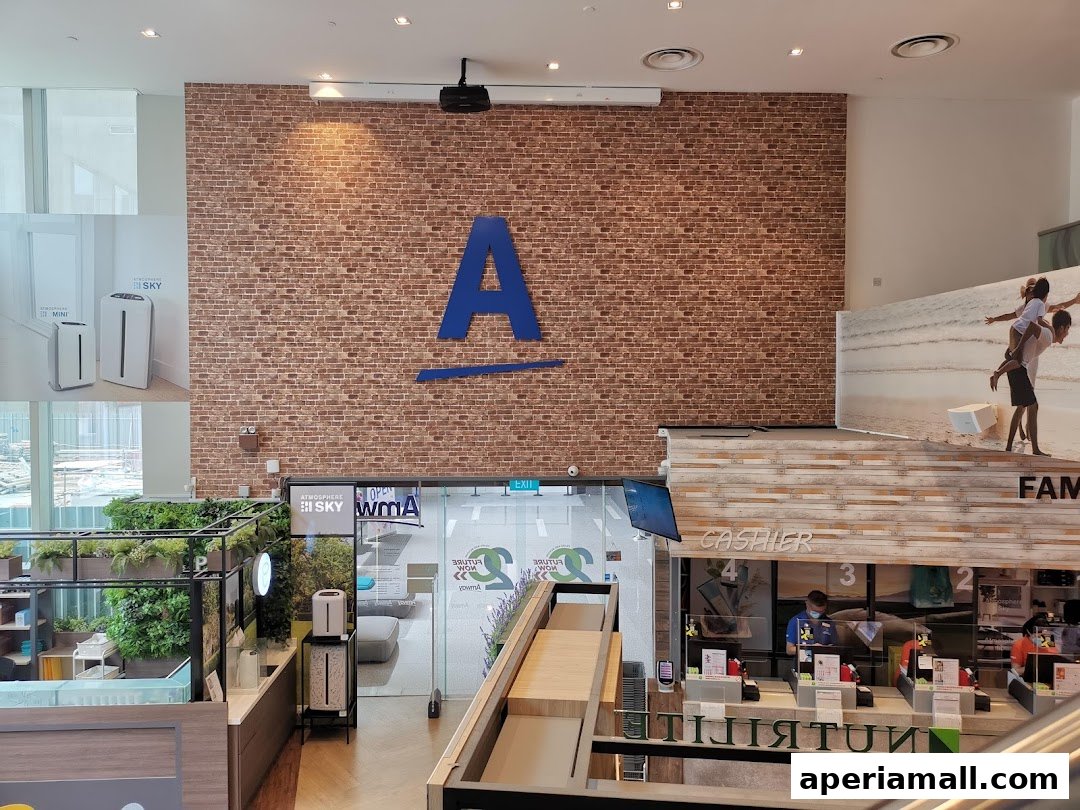 Interior view of a Nutrilite shop with a large 'A' logo, product displays, and cashier counters.