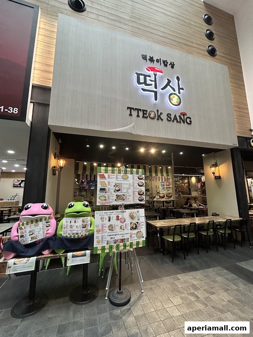 The storefront of TTEOK SANG, a Korean restaurant, with menus displayed outside.