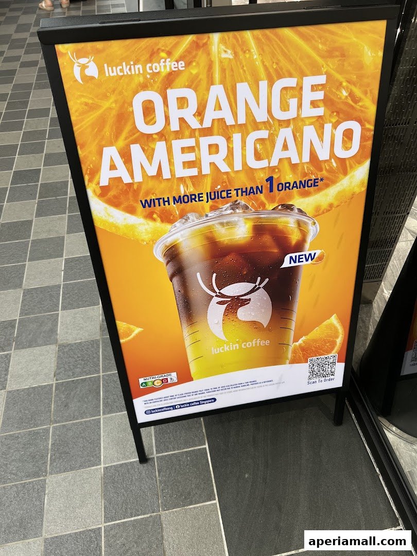 A Luckin Coffee A-frame sign advertises their new Orange Americano drink.