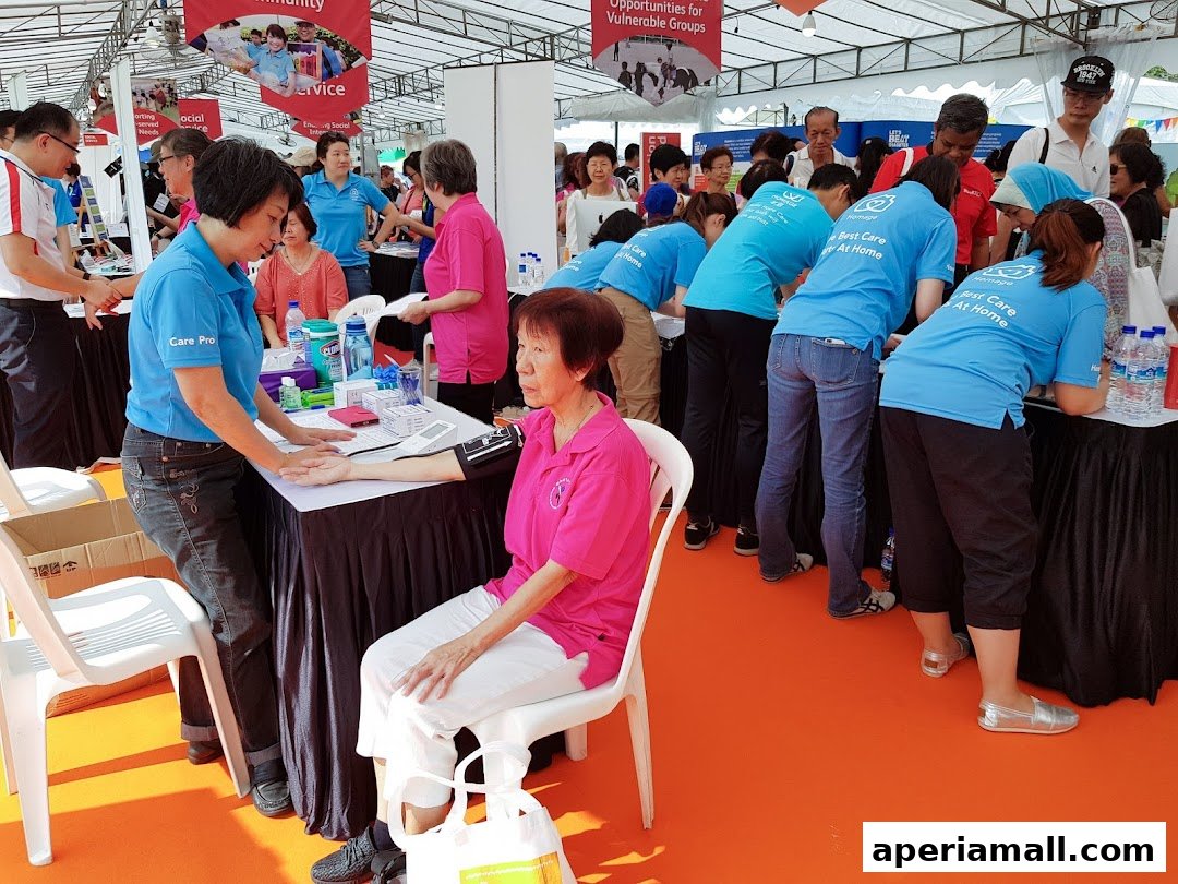 Staff providing health checks at a community event, with a focus on home care services.