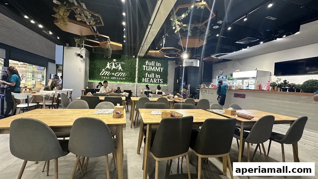 Interior of Im-Em Thai Kitchen with tables, chairs, and a counter.