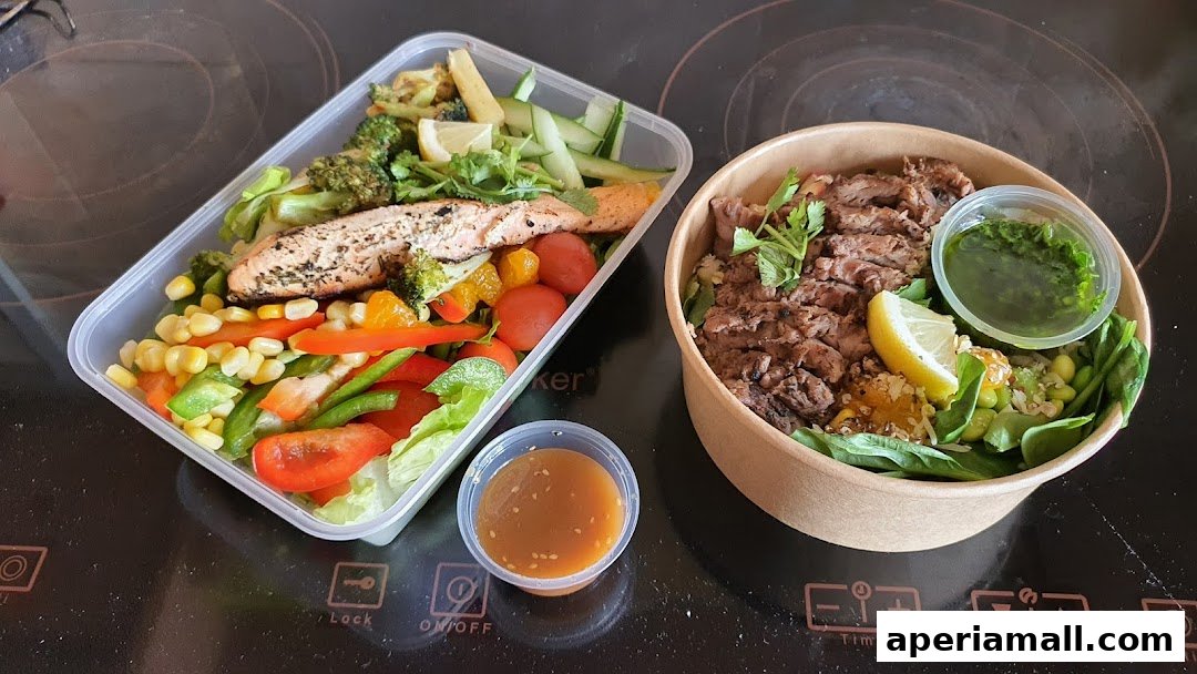 Two healthy salad bowls, one with salmon and vegetables, the other with steak and greens.