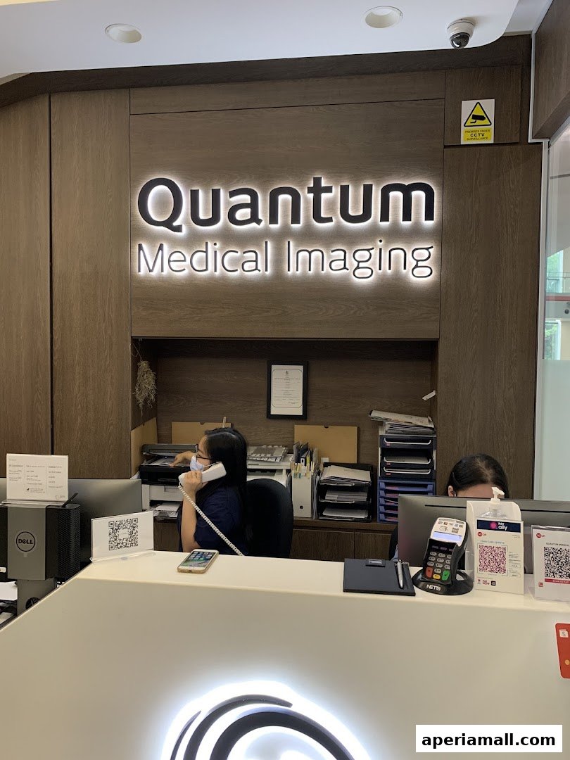Reception area of Quantum Medical Imaging with staff and signage.