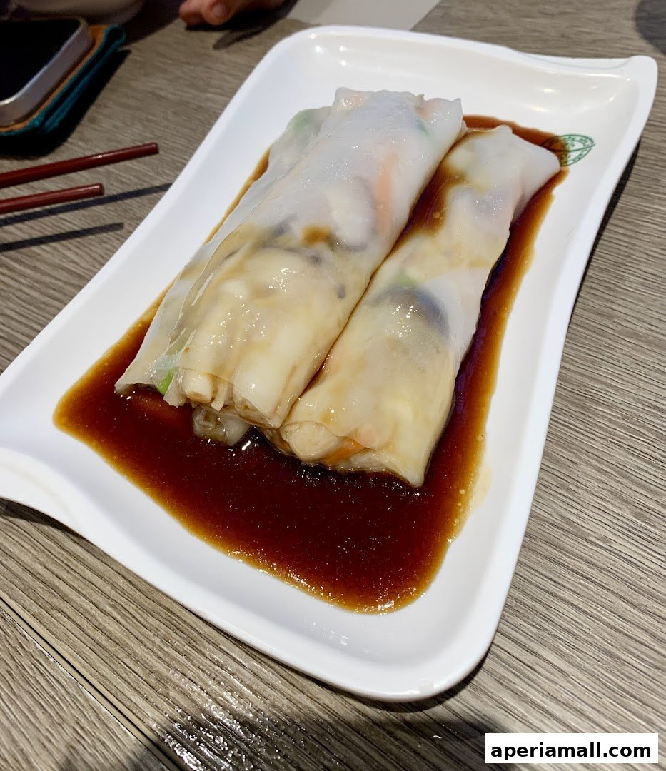 A plate of delicious steamed rice noodle rolls with a savory sauce.