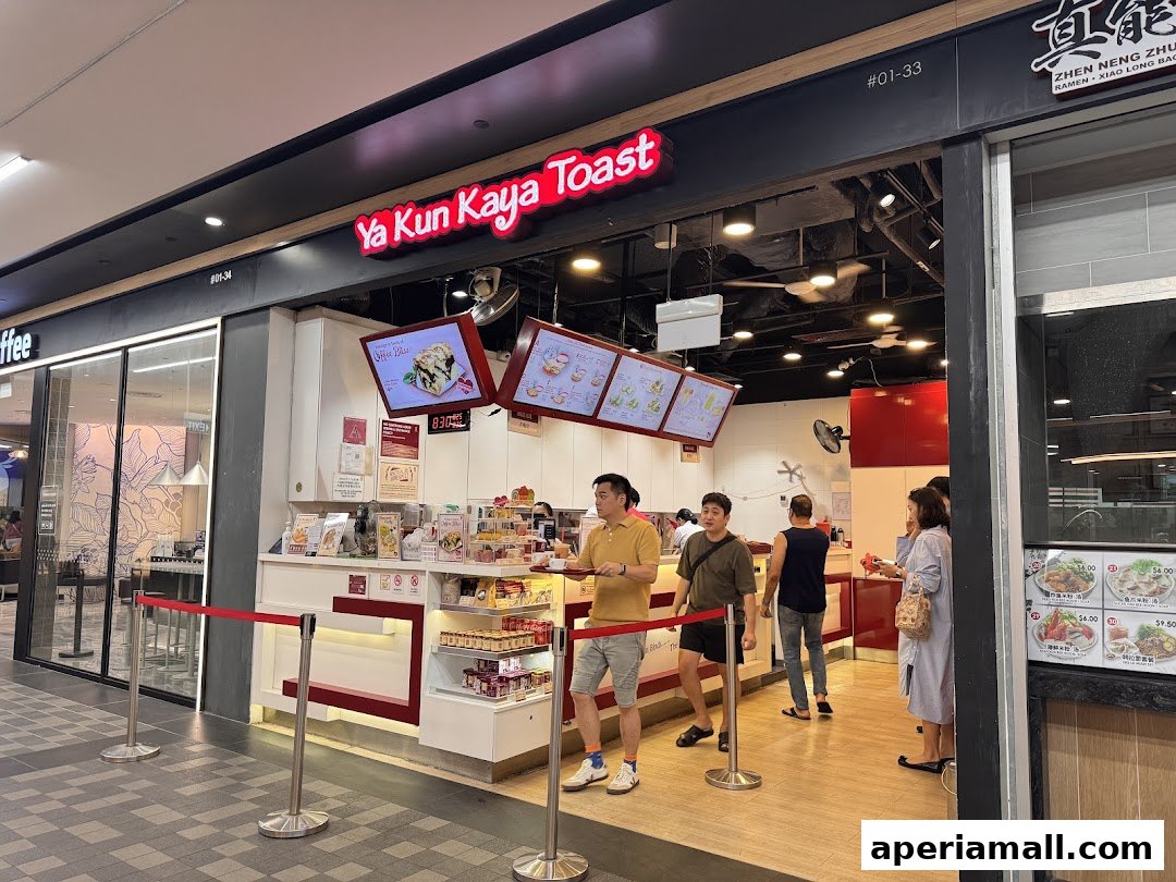 The entrance of Ya Kun Kaya Toast with customers queuing and menu displays.