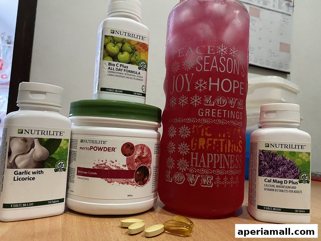 A collection of Nutrilite health supplements including Bio C Plus, Garlic with Licorice, PhytoPowder, and Cal Mag D Plus.