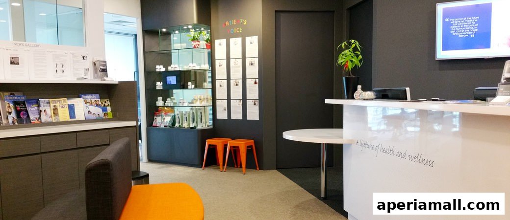 The reception area of Bodyworks Chiropractic Singapore, featuring a counter, seating, and informational displays.