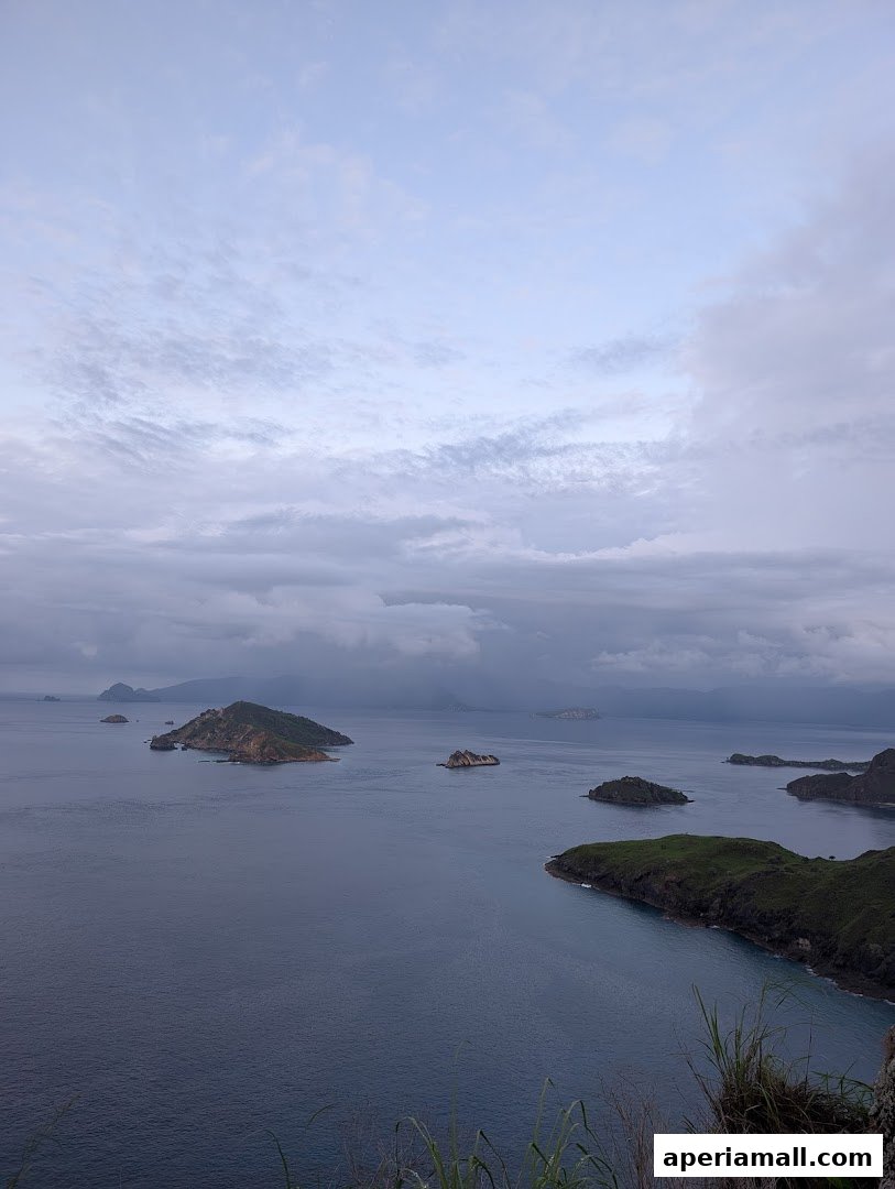 A serene seascape with scattered islands under a cloudy sky.