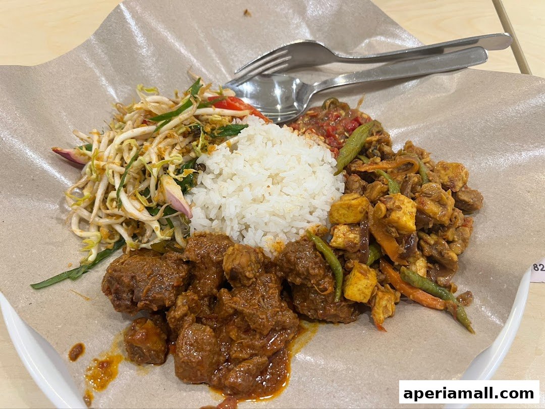 A plate of rice with various meat dishes and a side of bean sprouts.