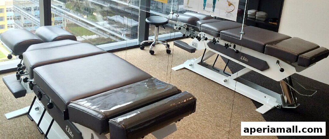 Two chiropractic adjustment tables are shown in a clean, modern clinic room with large windows.