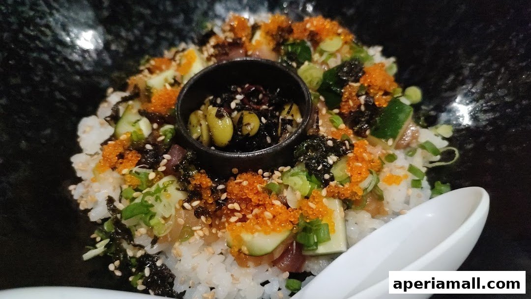 A close-up of a delicious donburi bowl filled with rice, fish, and various toppings.