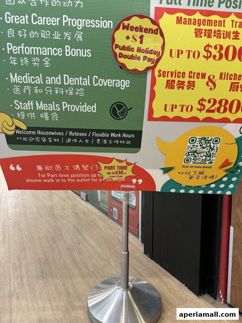 A sign advertising job opportunities with benefits like career progression and bonuses.