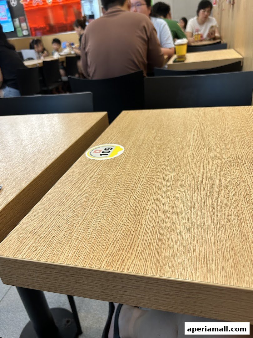 Interior shot of a McDonald's restaurant with people dining at tables.