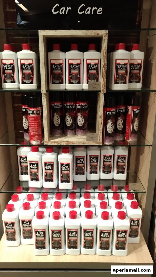 Shelves stocked with various car care products including silicone glaze, tyre shine, and car wash liquid.