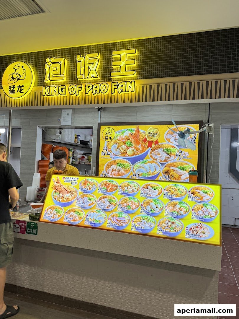 A food stall with a bright menu displaying various noodle and rice dishes.