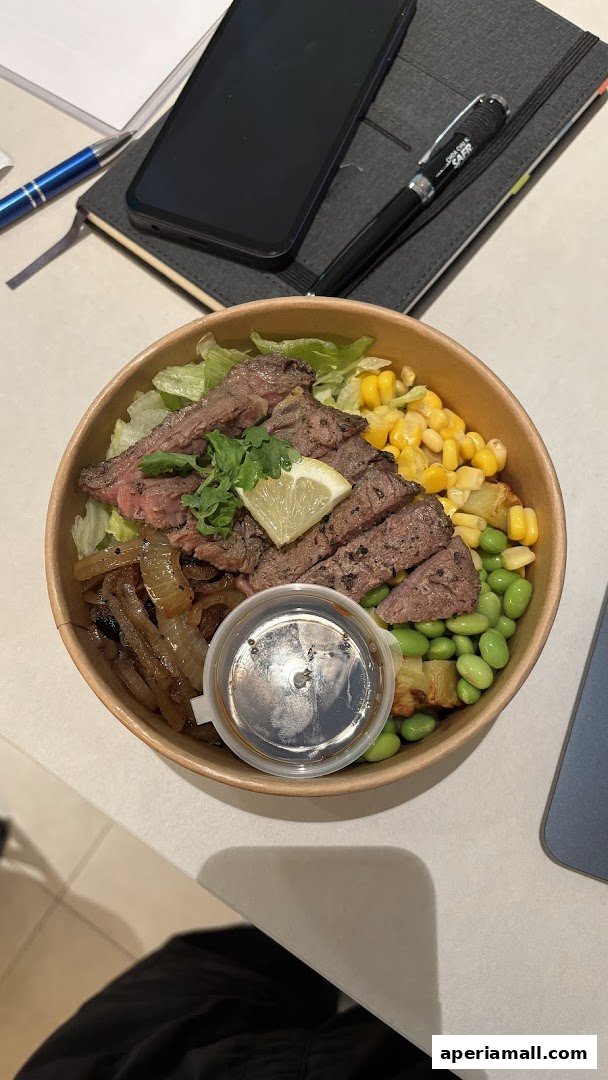 A delicious protein-packed salad bowl with steak, corn, edamame, and onions.
