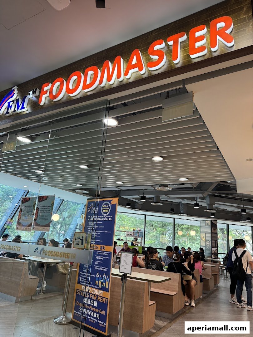 The entrance of FM FoodMaster, a bustling food court with customers seated at tables.