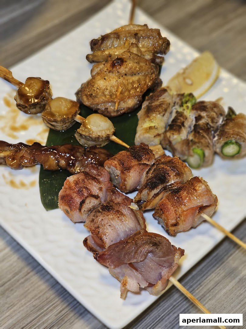 A plate of assorted grilled skewers, including chicken wings, scallops, and bacon-wrapped items.