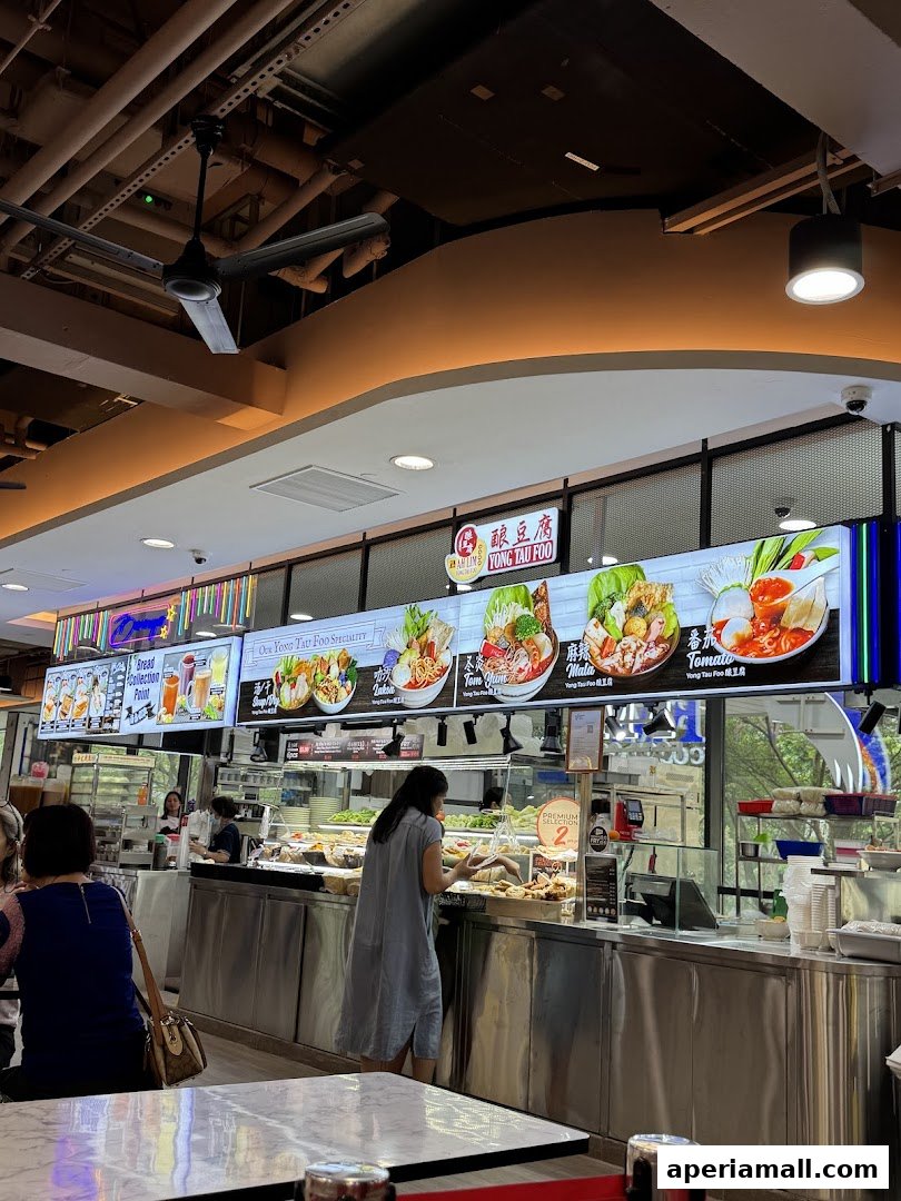 A food stall with digital menus displaying various Yong Tau Foo dishes and drinks.