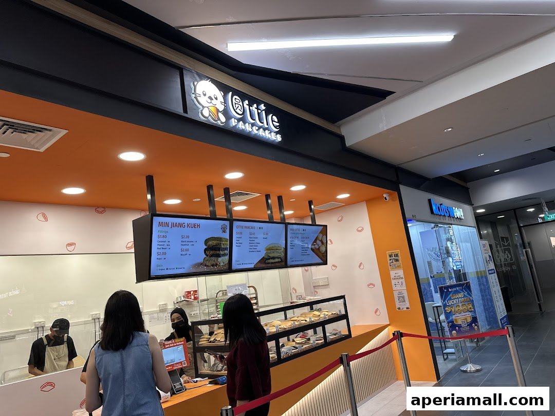 A bright and inviting Ottie Pancakes shop with a digital menu displaying various pancake options.