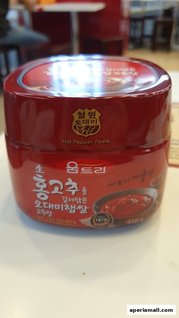 A jar of Korean hot pepper paste with Korean text and branding.