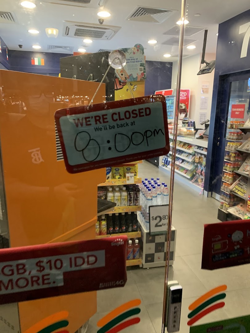 A 7-Eleven shop entrance with a 'We're Closed' sign on the glass door.
