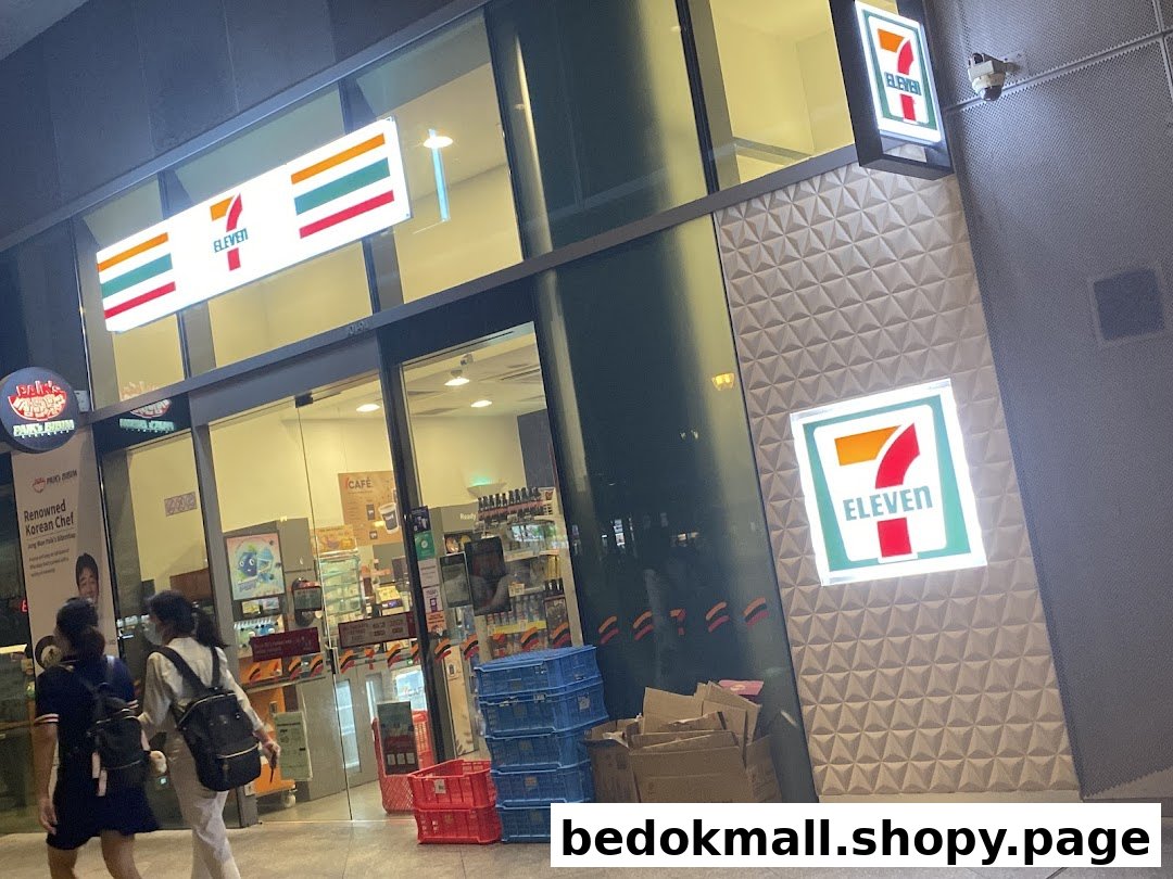 Exterior view of a brightly lit 7-Eleven convenience store at night.