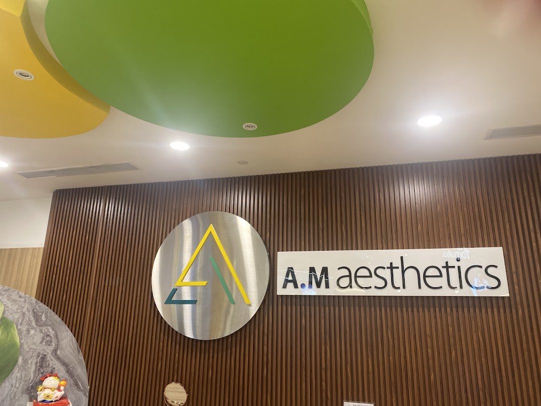 Shop name and logo on a wooden slatted wall with colorful ceiling.