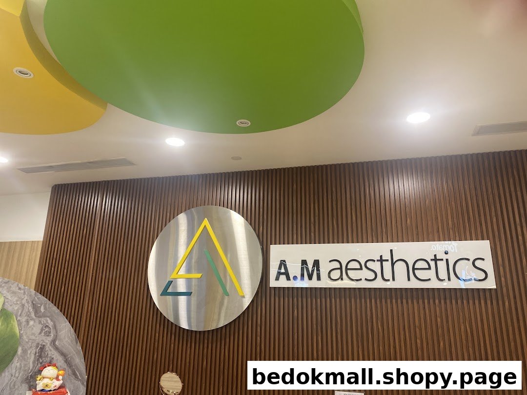 Shop name and logo on a wooden slatted wall with colorful ceiling.