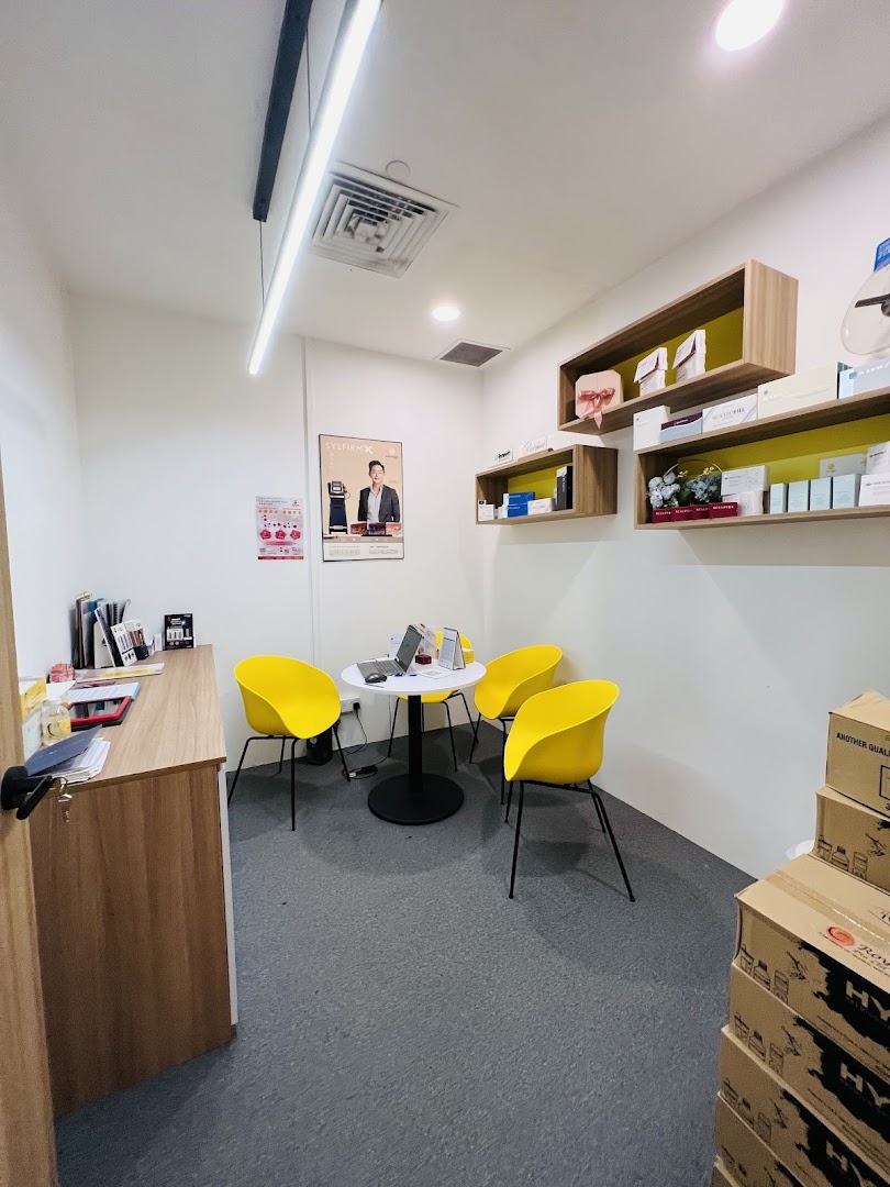 Interior view of a shop with a waiting area, product shelves, and stacked boxes.
