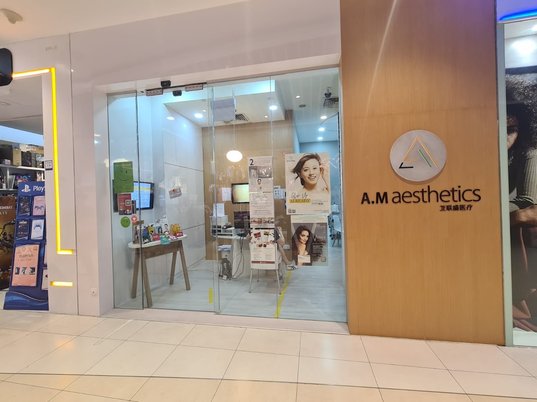 Glass entrance of A.M Aesthetics shop with logo and interior visible.