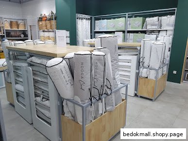 Interior view of a bedding shop with various packaged products on display.