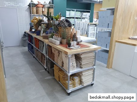 Interior view of a home goods store with a central display table.