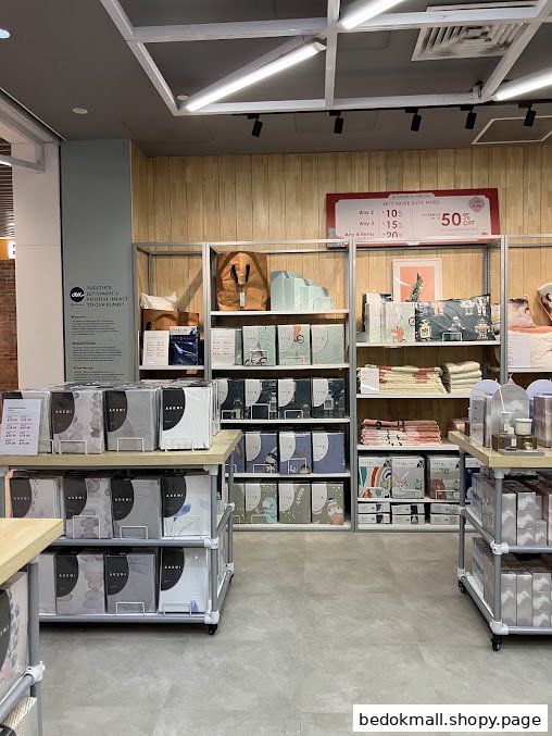 Interior view of a retail shop displaying home textile products on shelves.