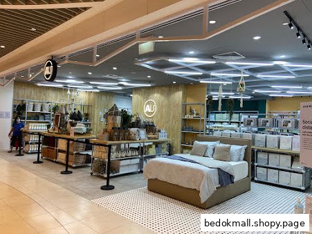 Interior view of a home goods store with bedding and furniture displays.